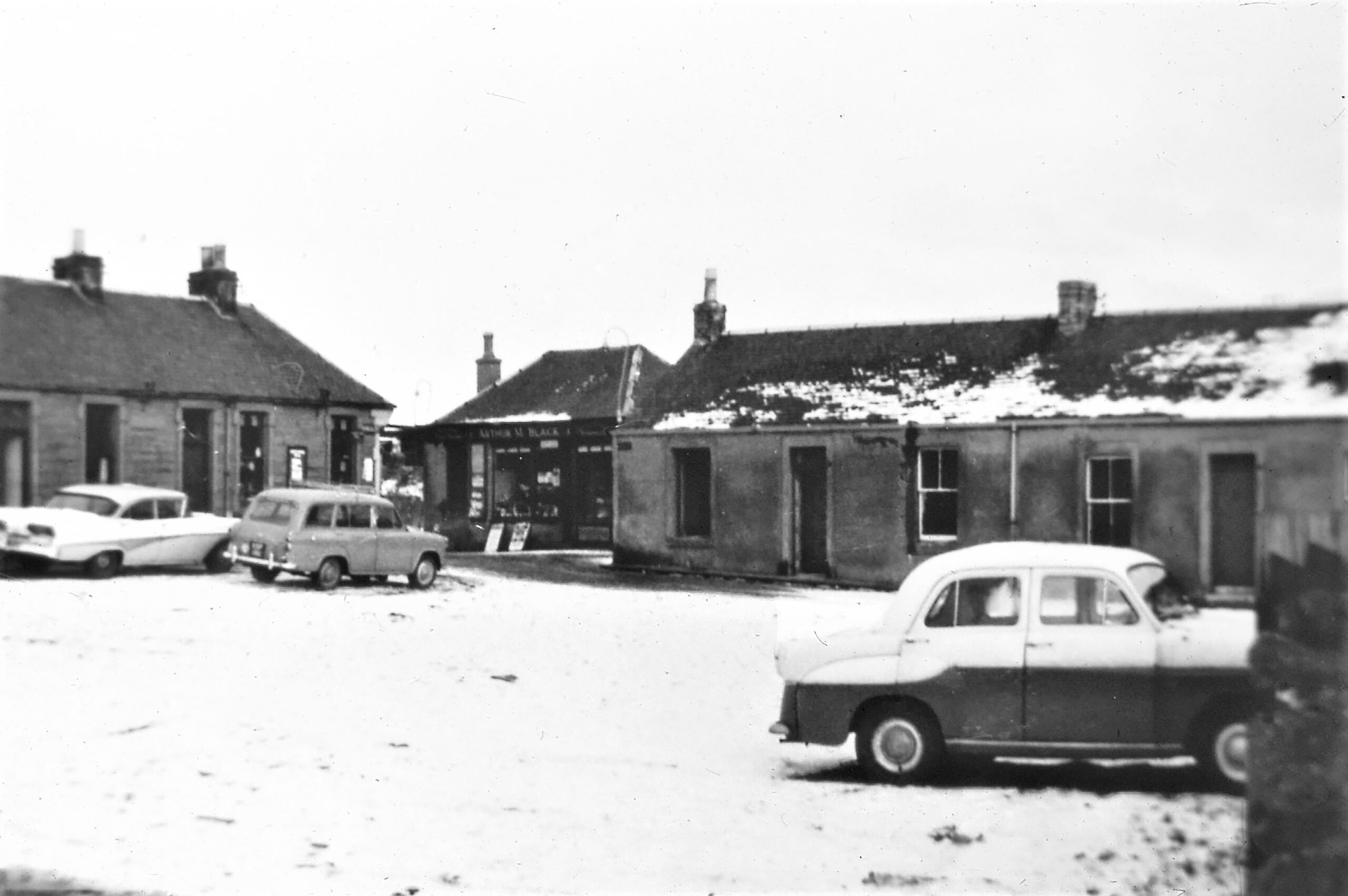 Tayport Heritage Trail - Board 15 - The view towards Gladstone Square on the left (now the Dolphin Centre) and Bridge Lane on the right showing Arthur Black's shops at top of Mill Lane post demolition of Nicoll Square