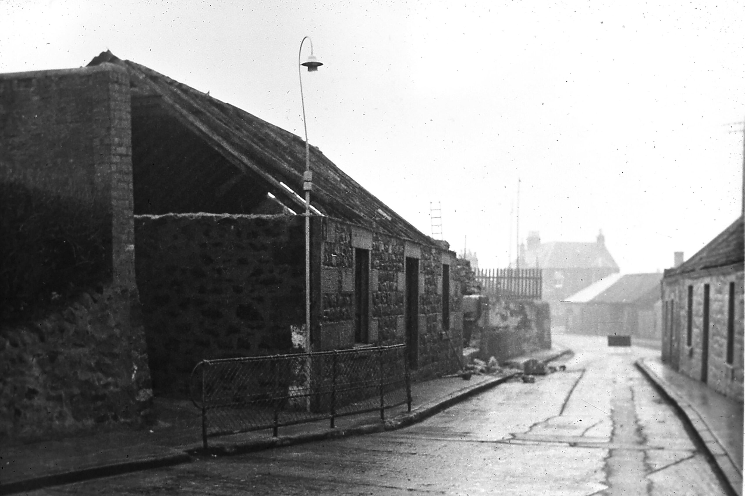 Tayport Heritage Trail - Board 22 - Demolition at foot of lane leading to the rear entrance of the school, with Greenside Place in the background.